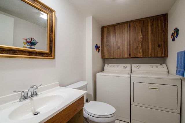 bathroom with vanity, toilet, and separate washer and dryer