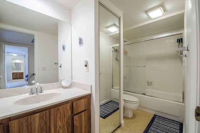 full bathroom with toilet, vanity, and bath / shower combo with glass door