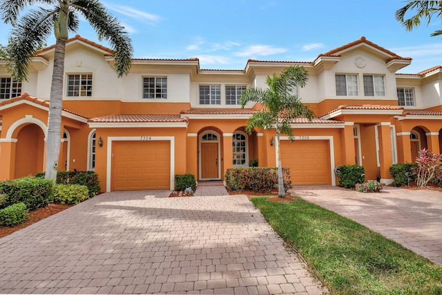 mediterranean / spanish-style house with a garage