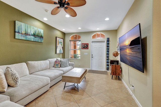 living room with ceiling fan and light tile patterned floors