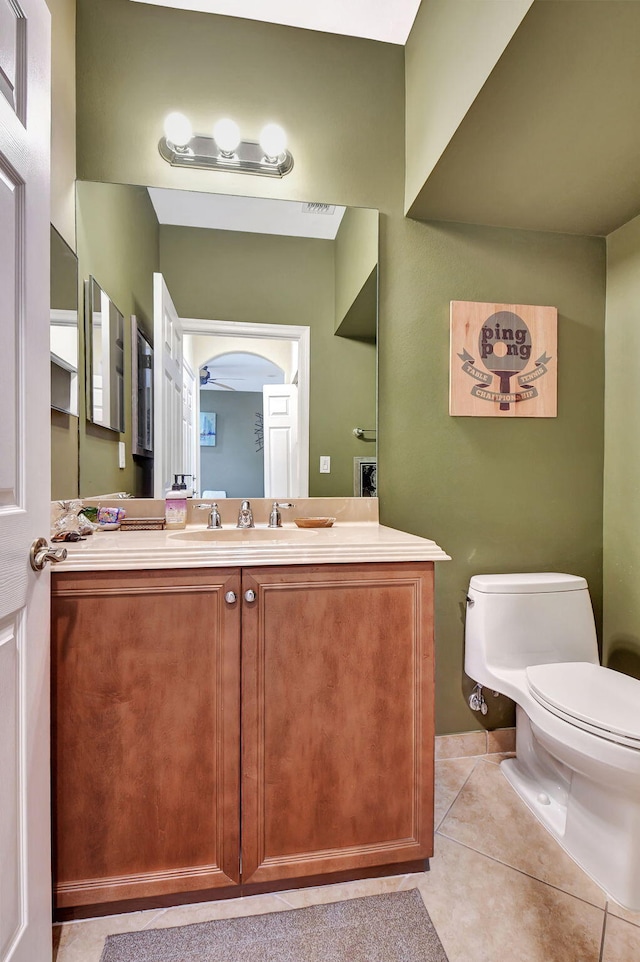 bathroom featuring vanity, tile patterned floors, and toilet