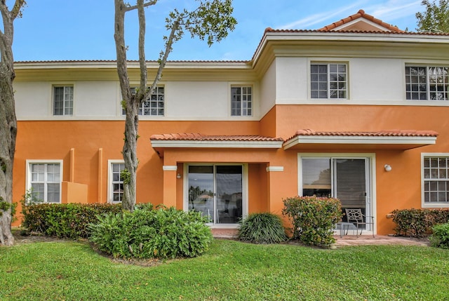 rear view of property with a yard