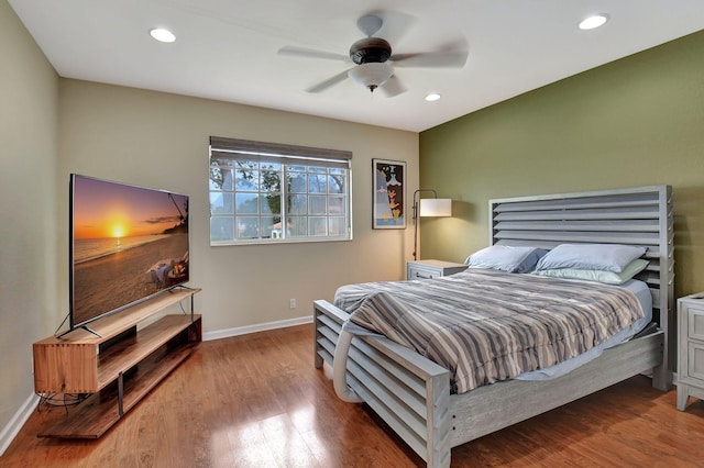 bedroom with hardwood / wood-style floors and ceiling fan