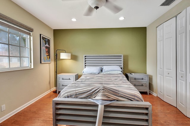 bedroom with a closet, ceiling fan, and light wood-type flooring