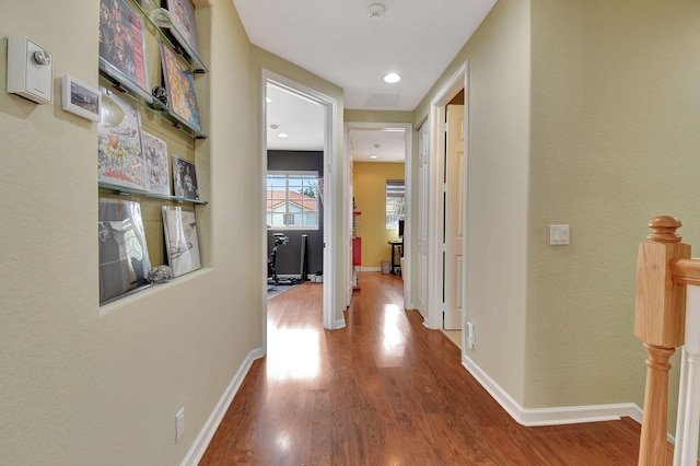 hallway with hardwood / wood-style flooring