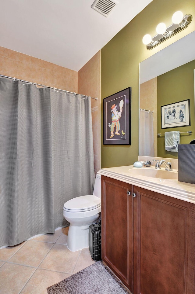 bathroom featuring vanity, tile patterned floors, and toilet