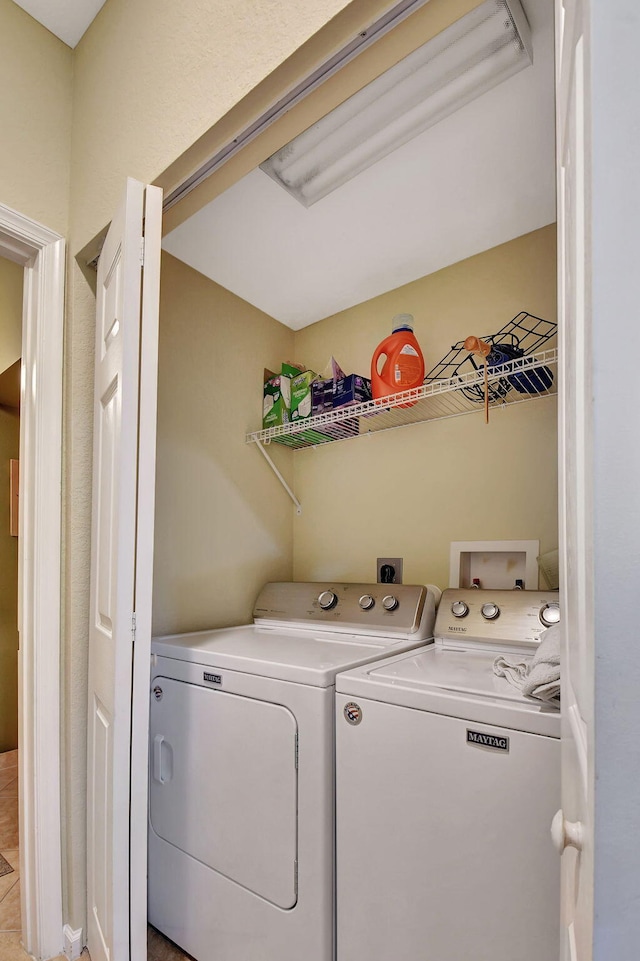 clothes washing area featuring washer and clothes dryer