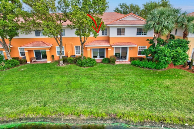 rear view of house with a lawn