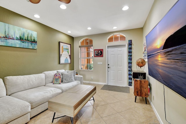 living room featuring light tile patterned floors and ceiling fan