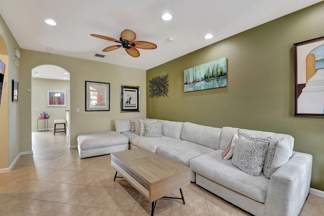 tiled living room with ceiling fan