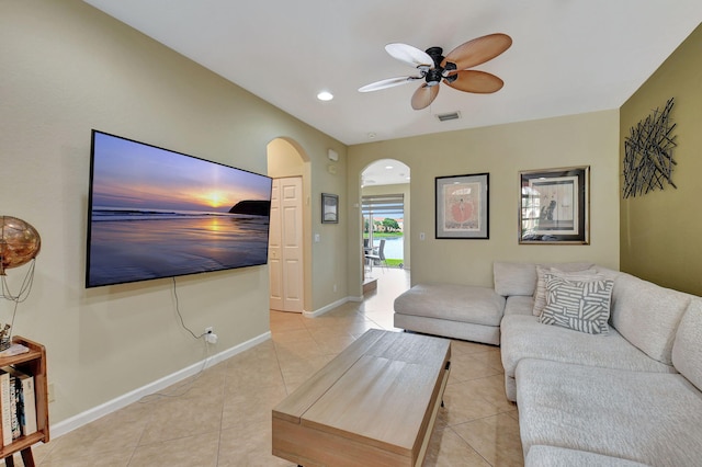 tiled living room with ceiling fan