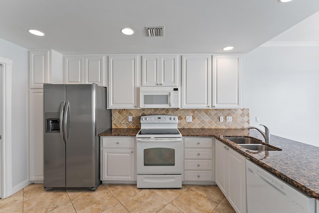 kitchen featuring white cabinetry, sink, white appliances, and light tile patterned floors