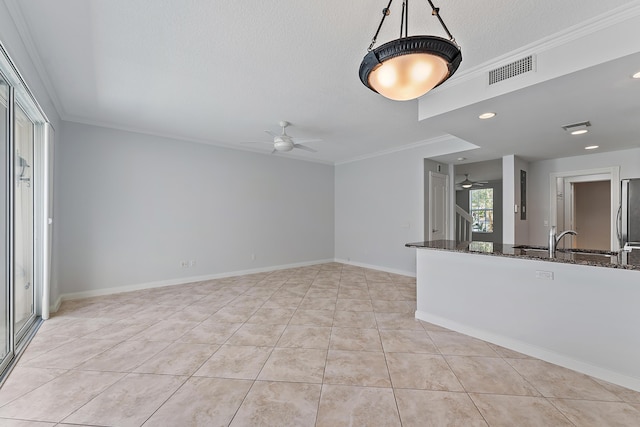 unfurnished living room with light tile patterned floors, crown molding, a textured ceiling, and ceiling fan