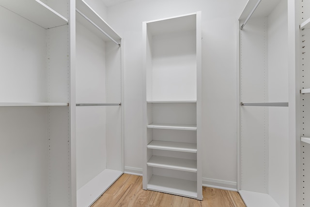 spacious closet featuring hardwood / wood-style flooring