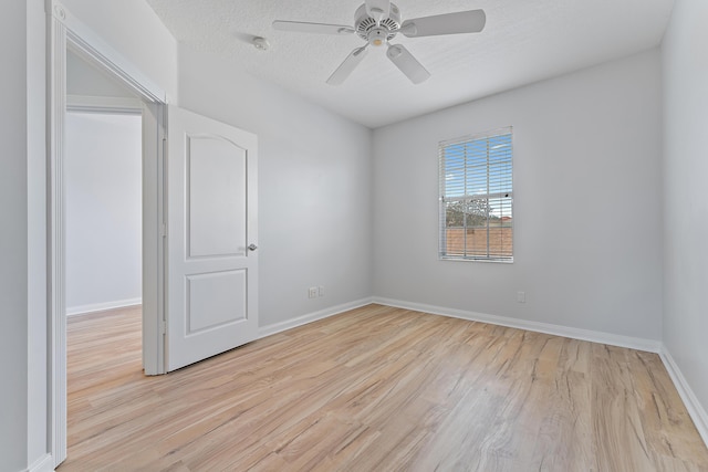 spare room featuring ceiling fan, a textured ceiling, and light hardwood / wood-style floors