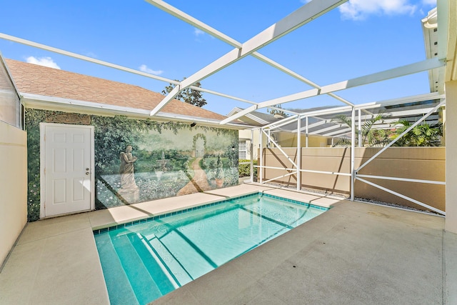 view of swimming pool featuring a patio area and glass enclosure