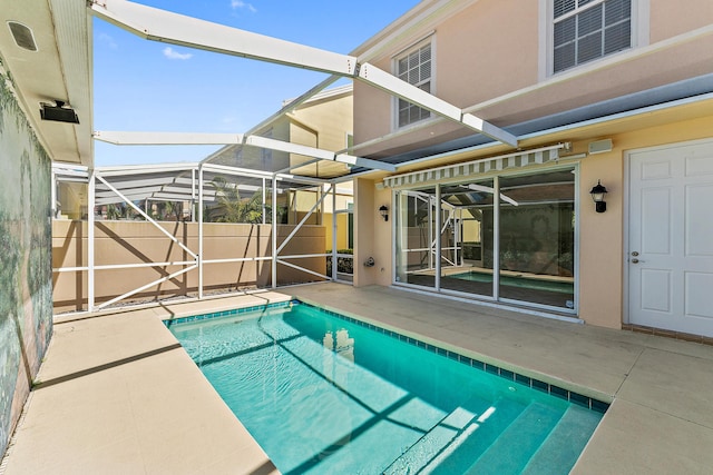 view of swimming pool with a lanai and a patio