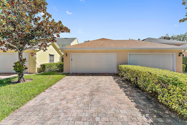 view of front of home featuring a garage and a front lawn