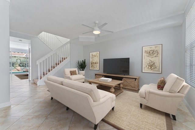 living room with light tile patterned floors, ornamental molding, and ceiling fan