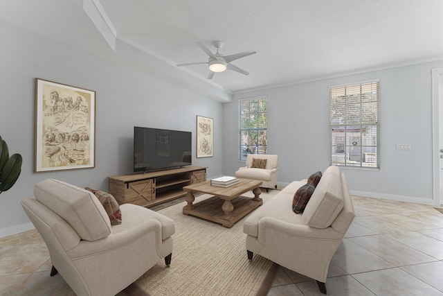 tiled living room featuring ornamental molding, a textured ceiling, and ceiling fan