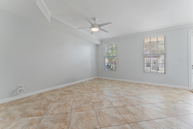 unfurnished room featuring ornamental molding, light tile patterned flooring, a textured ceiling, and ceiling fan