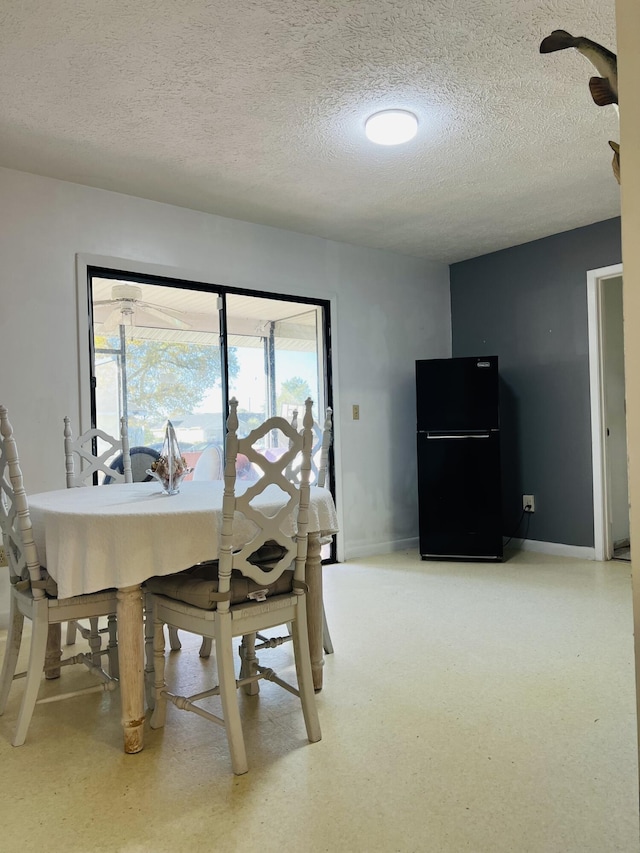 dining area featuring a textured ceiling