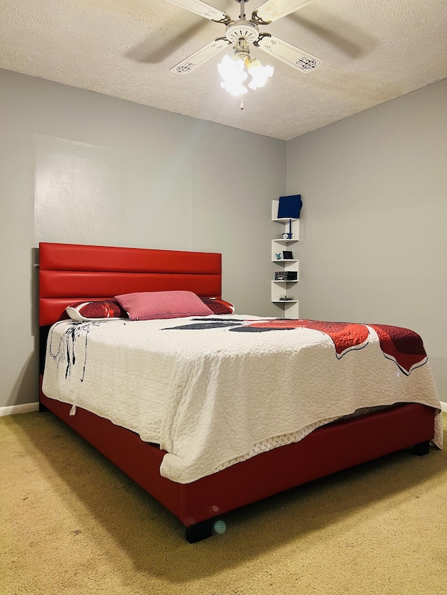 carpeted bedroom featuring a textured ceiling and ceiling fan