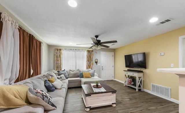 living room with ceiling fan and dark hardwood / wood-style flooring