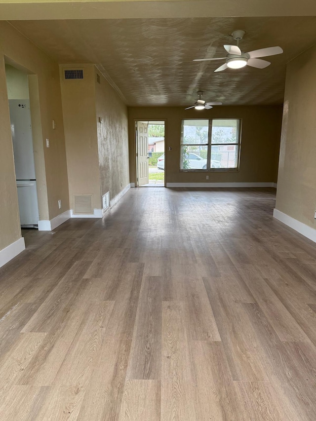 3740 NW 9th St, Fort Lauderdale, FL 33311 - unfurnished living room with ceiling fan, wood finished floors, and baseboards