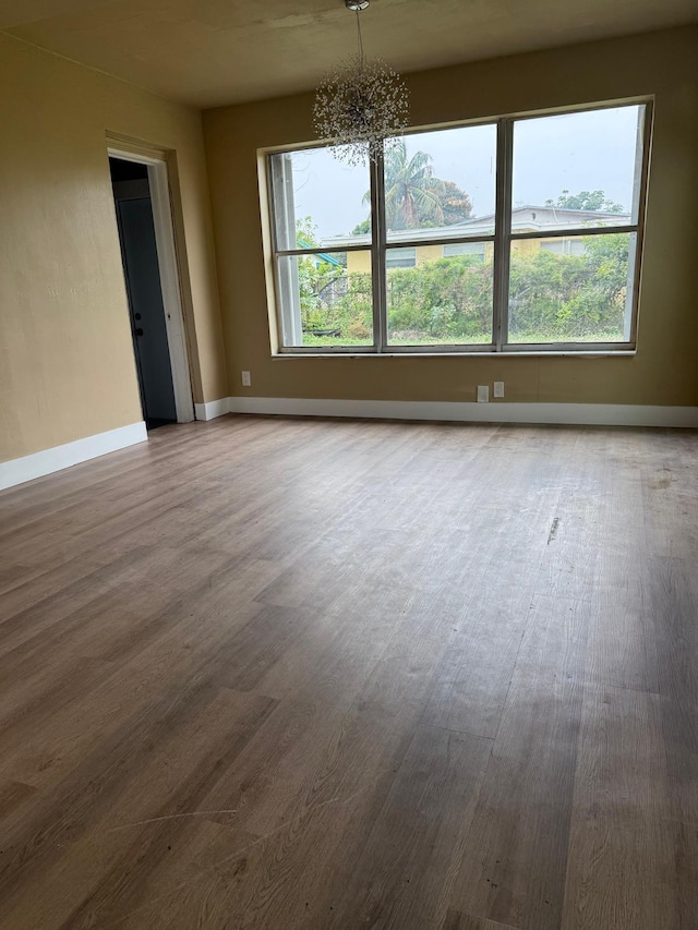 3740 NW 9th St, Fort Lauderdale, FL 33311 - unfurnished room with wood finished floors, a chandelier, and baseboards