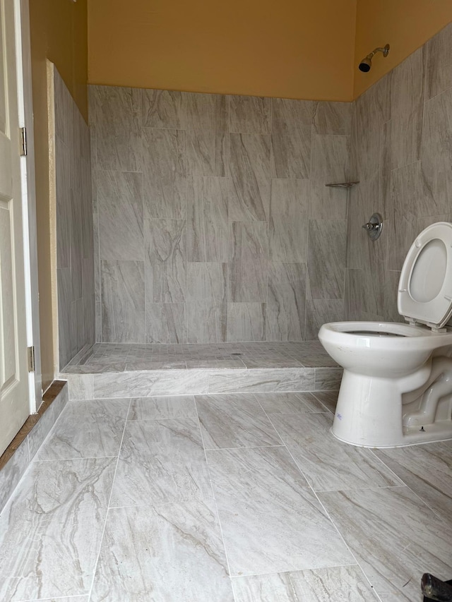 3740 NW 9th St, Fort Lauderdale, FL 33311 - full bathroom featuring toilet, a tile shower, marble look tile flooring, and tile walls