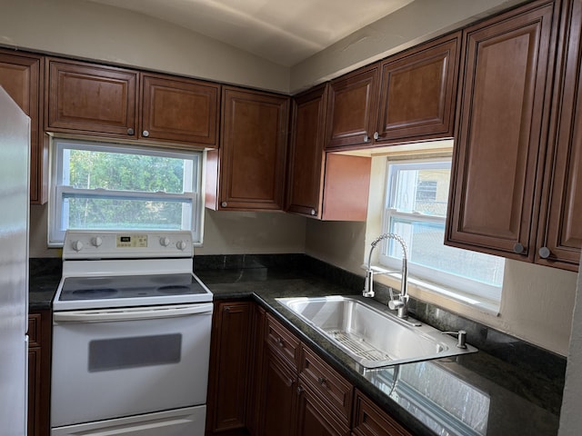 3740 NW 9th St, Fort Lauderdale, FL 33311 - kitchen with white electric range, a sink, stainless steel refrigerator, and dark brown cabinets