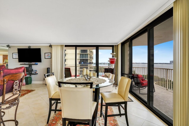 dining room with a wall of windows and light tile patterned floors