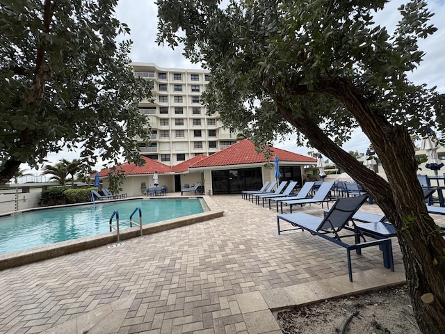 view of swimming pool featuring a patio area