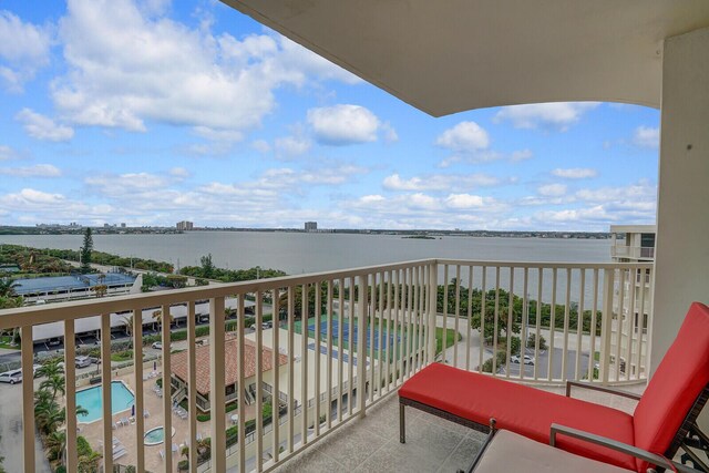 birds eye view of property with a water view and a beach view