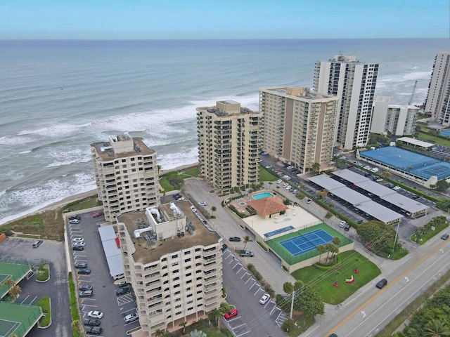 drone / aerial view featuring a water view and a beach view