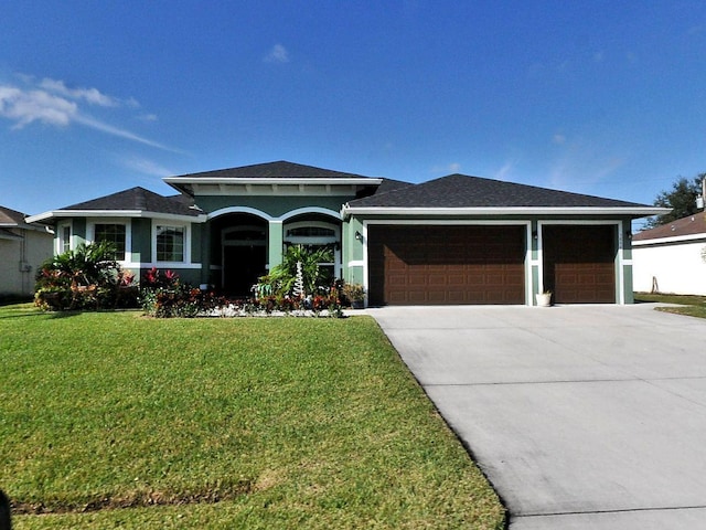 view of front of house featuring a garage and a front lawn