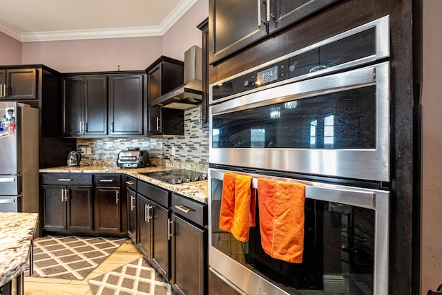 kitchen with stainless steel appliances, ornamental molding, light stone countertops, and wall chimney exhaust hood