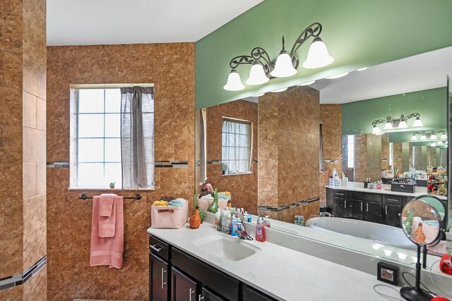 bathroom featuring vanity and tile walls