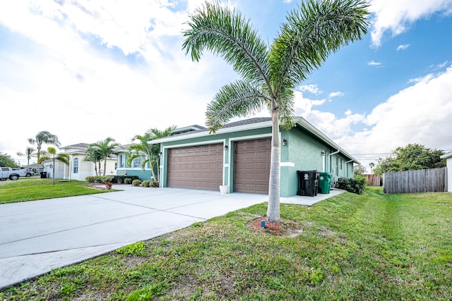 view of side of property with a garage and a lawn