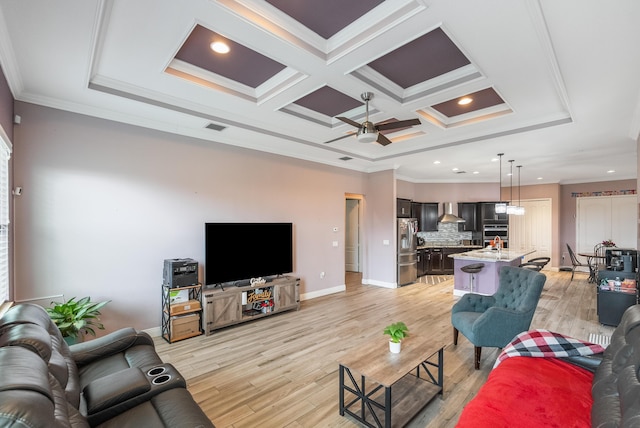 living room featuring crown molding, coffered ceiling, ceiling fan, and light hardwood / wood-style floors