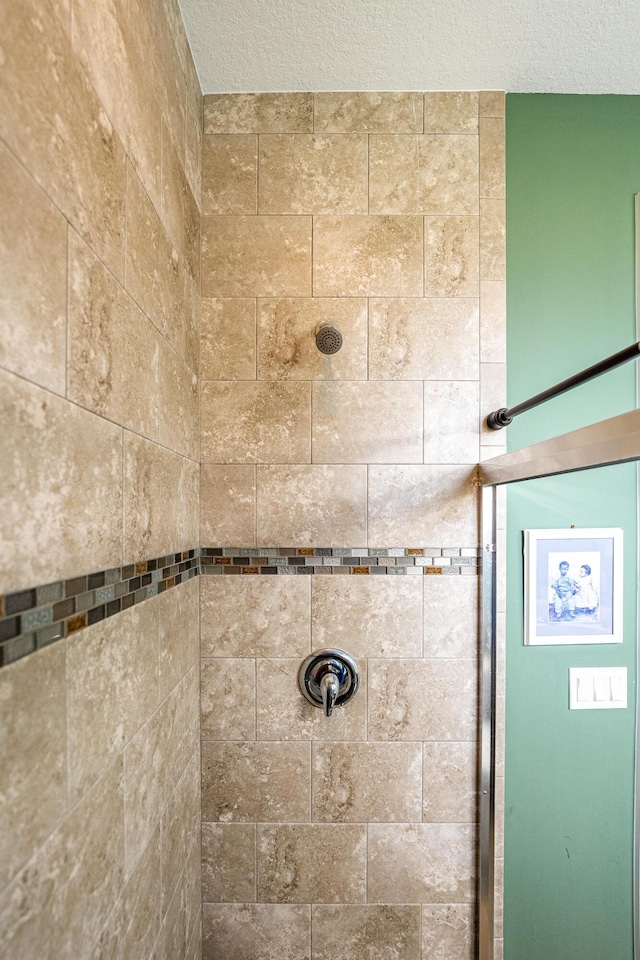 bathroom with a tile shower