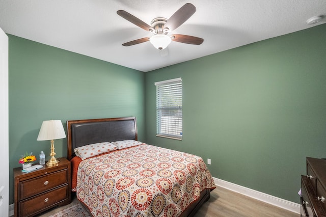 bedroom featuring light hardwood / wood-style floors and ceiling fan