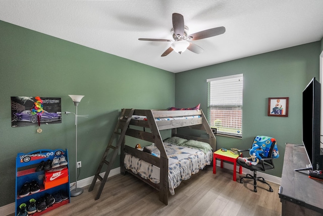 bedroom featuring hardwood / wood-style floors and ceiling fan