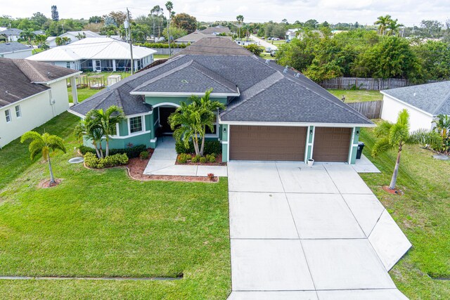 view of front of property featuring a garage and a front yard