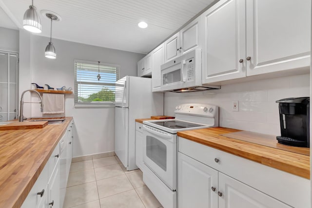 kitchen featuring butcher block counters, white cabinets, and white appliances