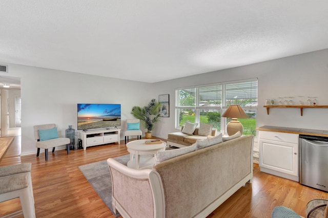 living room featuring indoor bar and light wood-type flooring