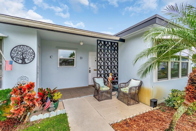 view of exterior entry with a patio area