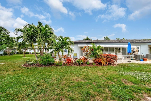 back of property featuring central AC, a yard, and a patio