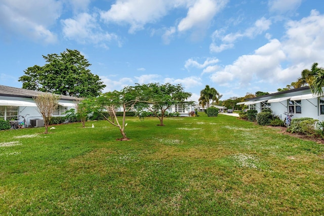 view of yard featuring central air condition unit